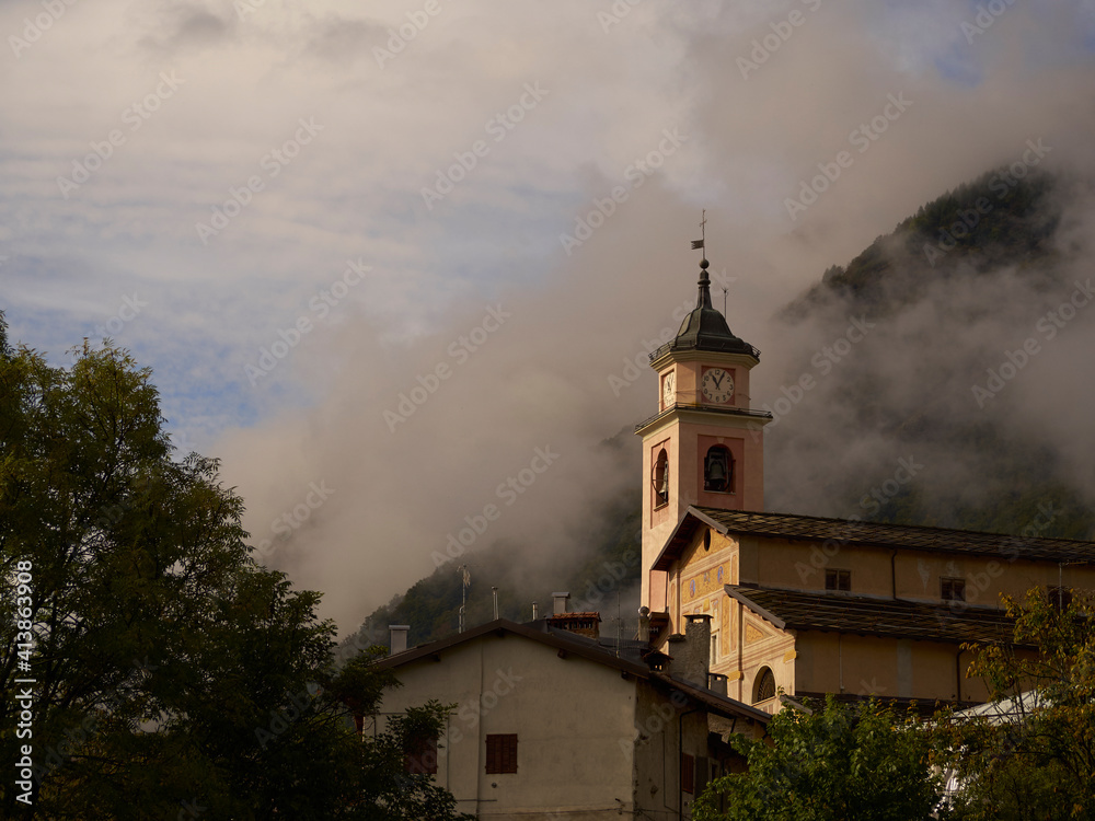 Village church, Entracuqe, Cuneo, Italy with the Maritime Alps in the background