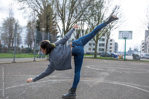 Flexible street dancer practicing freestyle dance photo