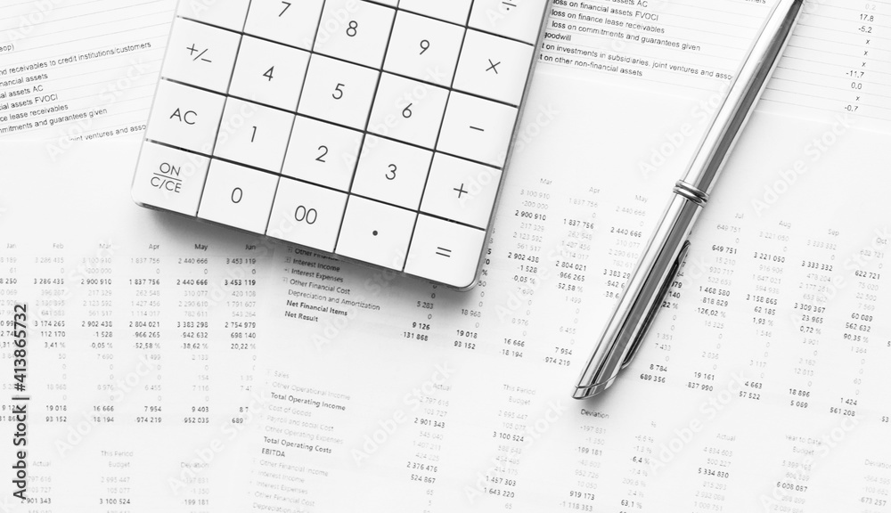 Calculator with pen on financial data. Concept of Business and Finance research . Calculator with pen on financial data. Concept of Business and Finance research .