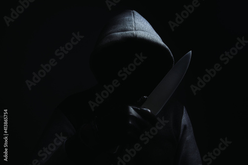 a man holding a large knife threatens