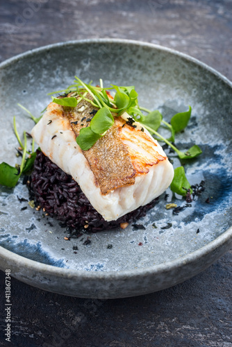 Photography Modern style traditional fried skrei cod fish filet with portulaca lettuce, and