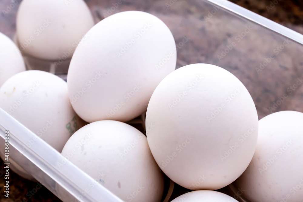A pile of round white farmers eggs stacked on one another on a marble countertop, fresh farm eggs from southwestern Ontario, Canada, February 2021. A pile of round white farmers eggs stacked on one another on a marble countertop, fresh farm eggs from southwestern Ontario, Canada, February 2021.