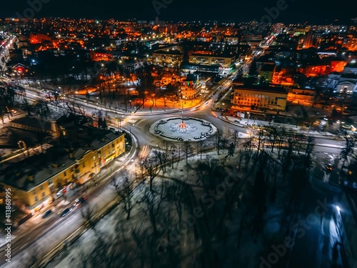 Night aerial view of roundabout road with circular cars in small european city