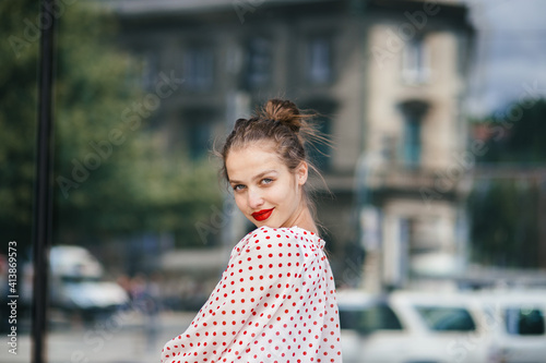 Young beautiful woman in the city wearing red lipstick photo