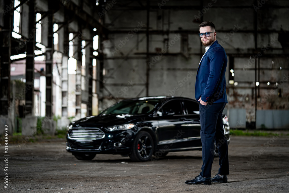 Fasion photoshooting of a man in elegant formal clothes. Young succesfull rich guy on black car background. Closeup. Fasion photoshooting of a man in elegant formal clothes. Young succesfull rich guy on black car background. Closeup.