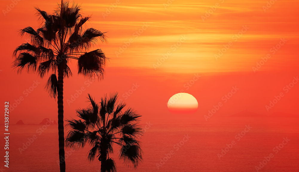 Sun and silhouettes of palm trees in sunset skies. Lima, Peru