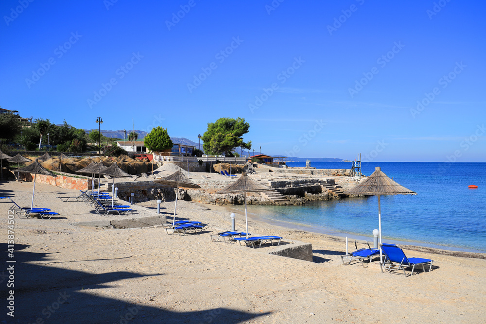 Beach with sun loungers and sun umbrellas in Ksamil resort