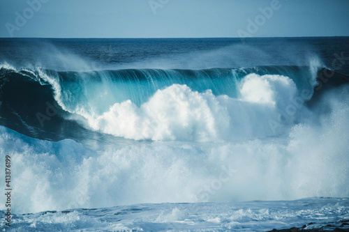 Scenic view of a big wave breaking in the sea against clear sky