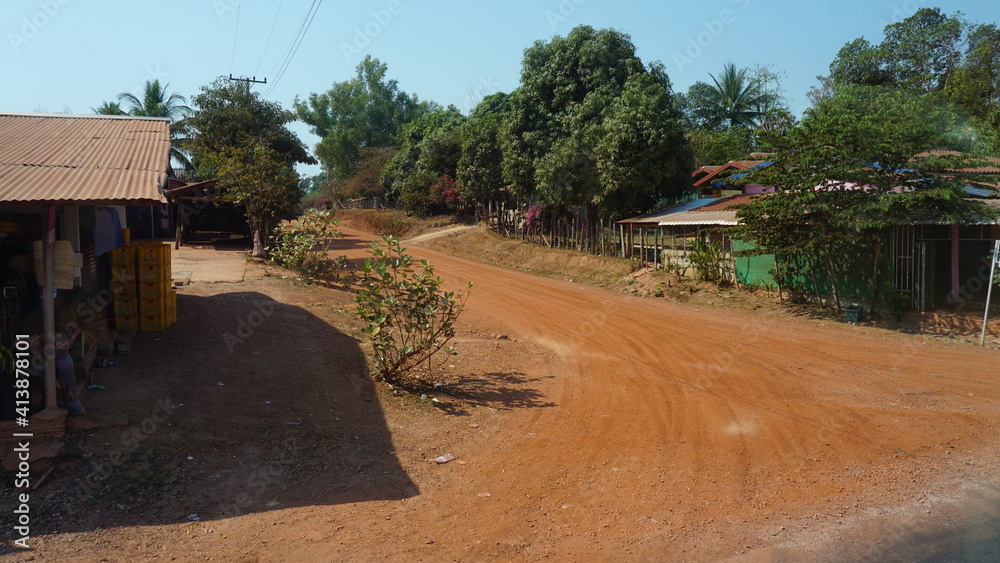 the view of some houses out of a bus window from Thakhek to Vientiane, Laos, February