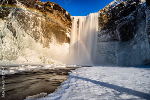 Waterfall and rainbow in Iceland photo