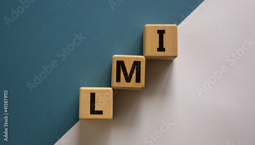 LMI, lenders mortgage insurance symbol. Wooden cubes form the word LMI, lenders mortgage insurance. Beautiful white blue background, copy space. Business and LMI, lenders mortgage insurance concept.
