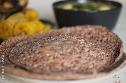 Hoppers made of finger millet served with egg stew prepared in Kerala style and steamed plantain. photo