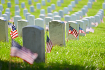 Headstones and National flags in Arlington National Cemetery - Circa Washington D.C. United States of America