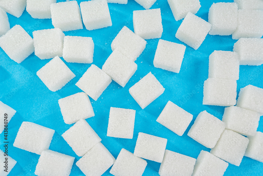 sugar cubes on a blue background. diabetes concept background. sugar cubes on a blue background. diabetes concept background.