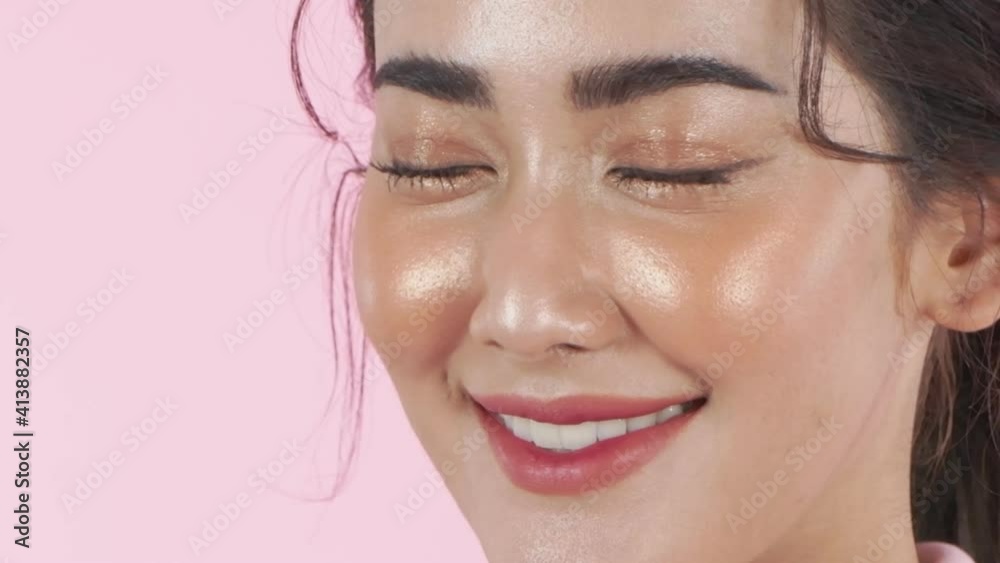Beauty concept of 4k Resolution. Asian woman opening eyes on a pink background. Beauty concept of 4k Resolution. Asian woman opening eyes on a pink background.