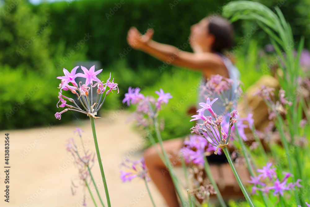 Flowers in front of a girl raising her arms. Flowers in front of a girl raising her arms.