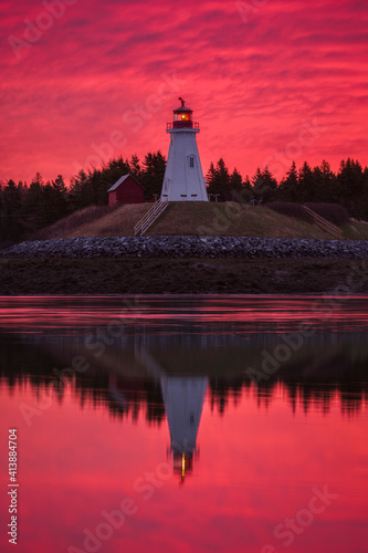 Dramatic red sky behind Mulholland Lighthouse in Canada photo