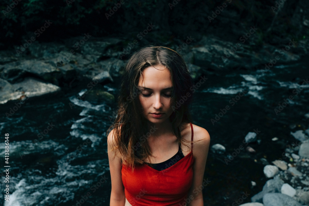 High angle view of woman with eyes closed standing in river at forest High angle view of woman with eyes closed standing in river at forest