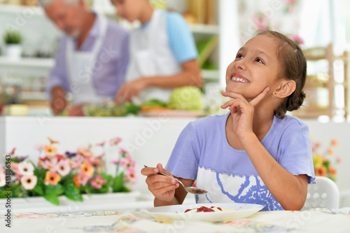 young girl eating   in the kitchen