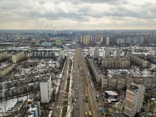 Kyiv road junction in light snow. Aerial drone view. Winter cloudy morning.