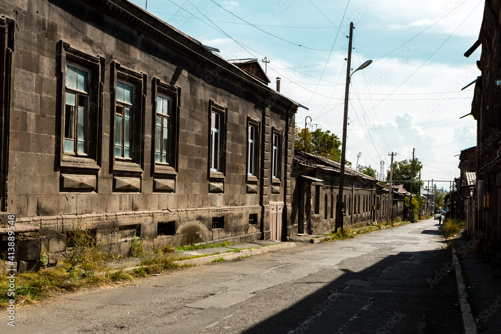 Old narrow street with wooden houses and stone road in Gyumri, Armenia