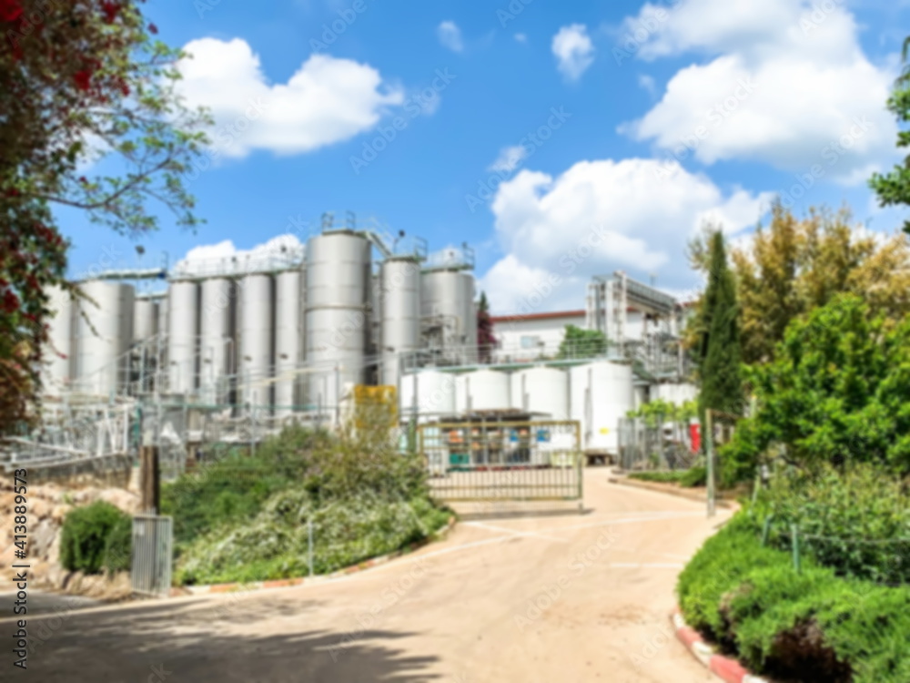 General blurred view of a modern winery with stainless steel barrels for wine fermentation