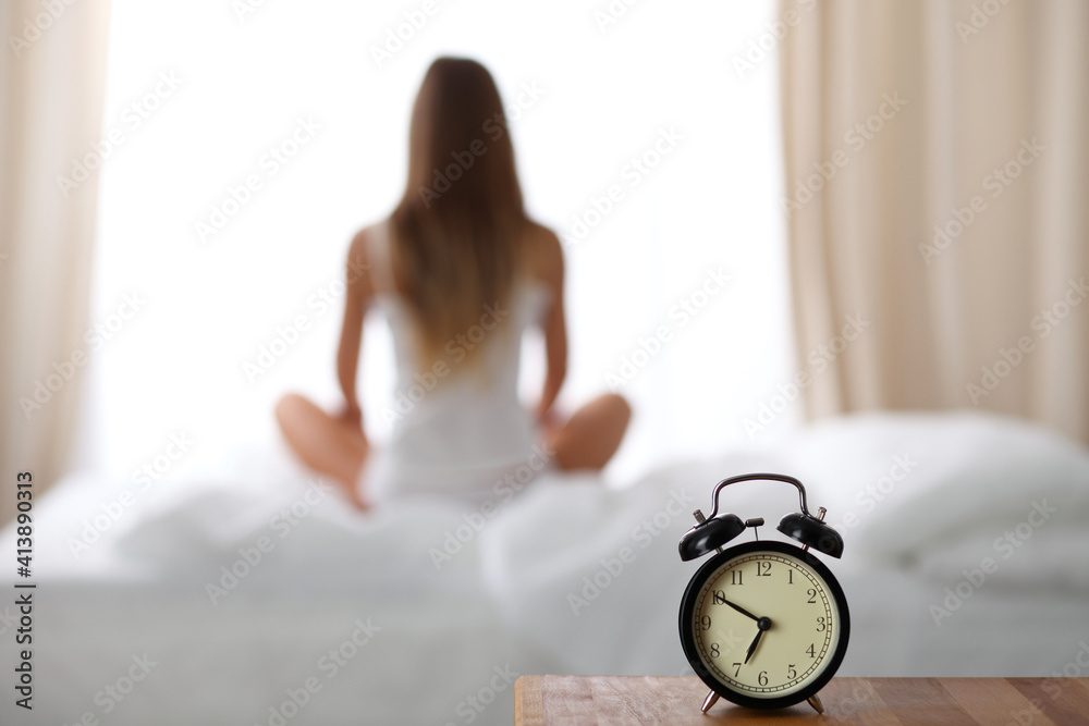 Woman stretching in bed after wake up, back view, entering a day happy and relaxed after good night sleep. Sweet dreams, good morning, new day, weekend, holidays concept Woman stretching in bed after wake up, back view, entering a day happy and relaxed after good night sleep. Sweet dreams, good morning, new day, weekend, holidays concept