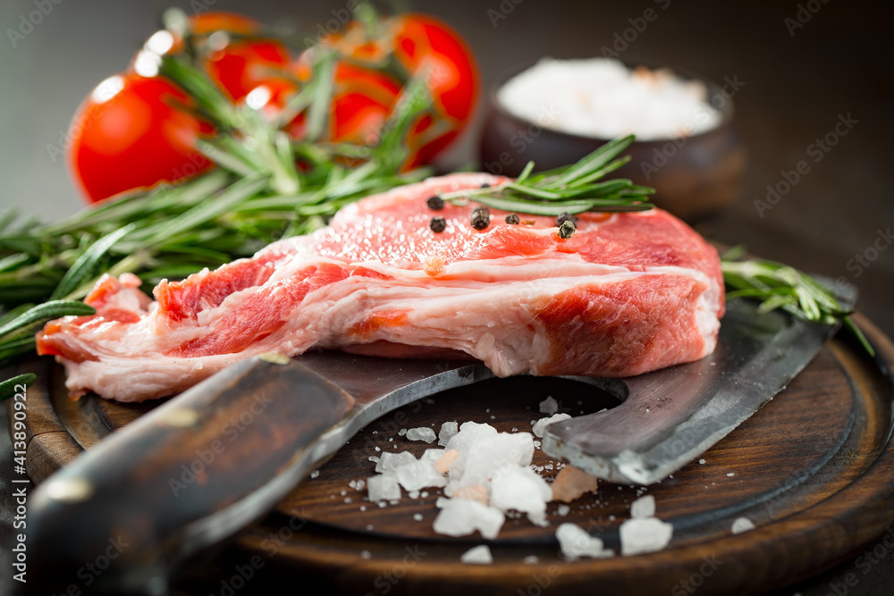 Raw meat with spices in a composition with kitchen accessories.