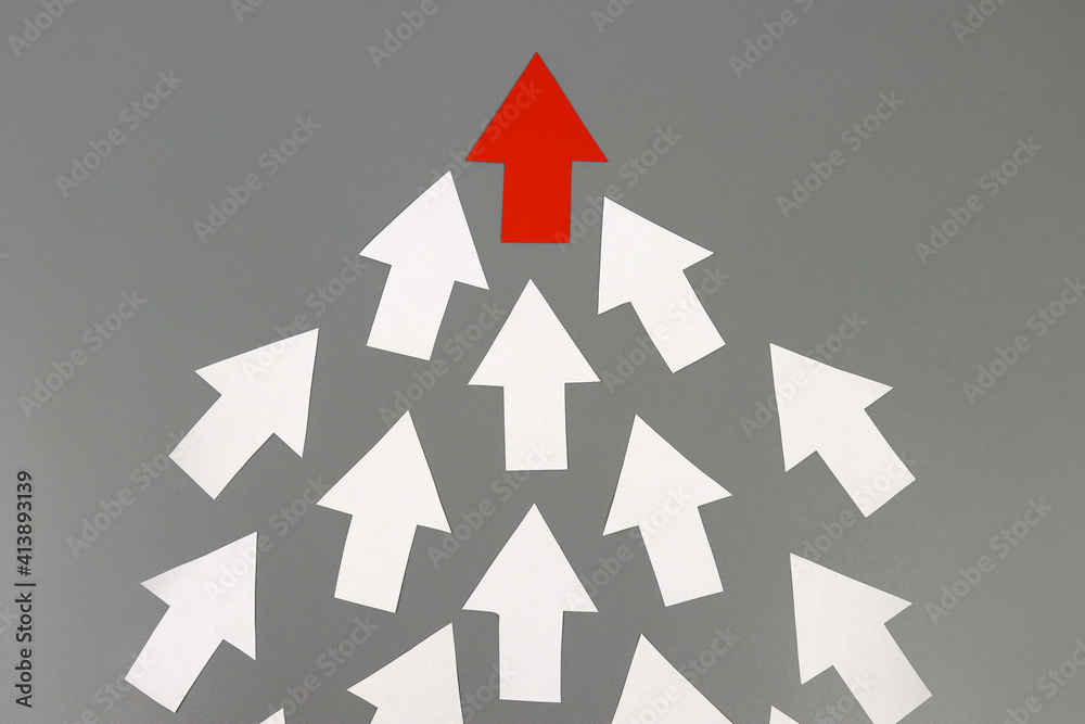 Red arrow leads many white arrows, a leadership concept Red arrow leads many white arrows, a leadership concept