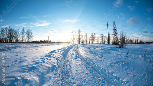 Winter landscape with snow road and sunset