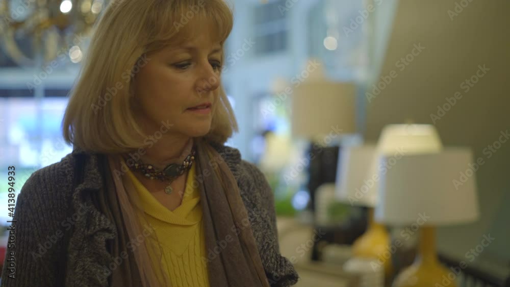 Caucasian Blonde Woman Walks Around an Antiques and Decor Store Caucasian Blonde Woman Walks Around an Antiques and Decor Store