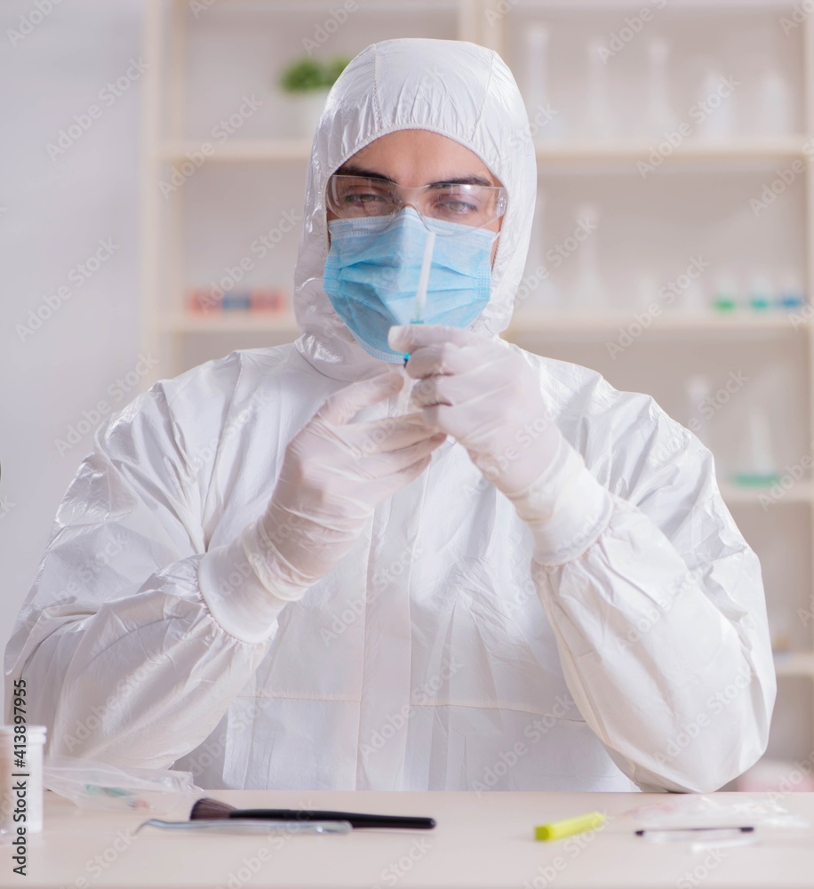Expert criminologist working in the lab for evidence Expert criminologist working in the lab for evidence