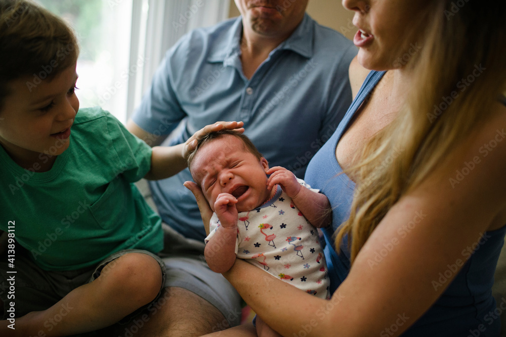 Midsection of parents with children sitting at home Midsection of parents with children sitting at home