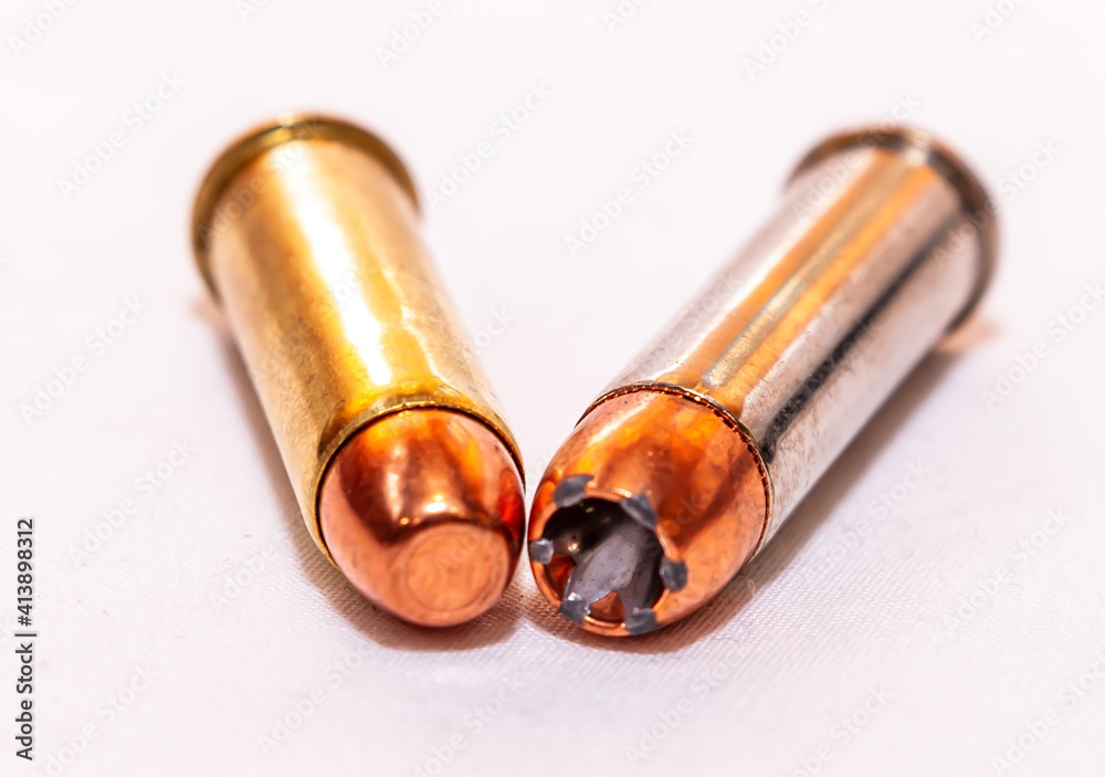 Two 38 special bullets, a hollow point and a full metal jacket on a white background Two 38 special bullets, a hollow point and a full metal jacket on a white background