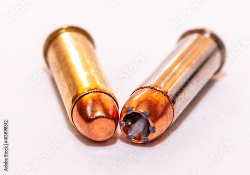 Fotografie Two 38 special bullets, a hollow point and a full metal jacket on a white backgr