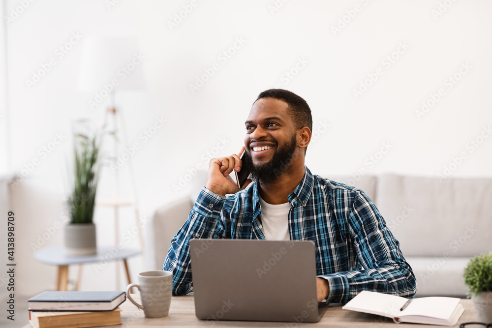 Smiling Black Businessman Talking On Phone Sitting In Modern Office Smiling Black Businessman Talking On Phone Sitting In Modern Office
