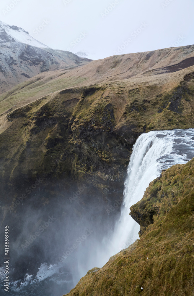 Scenic view of Skogafoss Waterfall on mountain Scenic view of Skogafoss Waterfall on mountain
