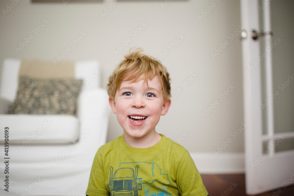 Cheerful boy sitting at home Cheerful boy sitting at home