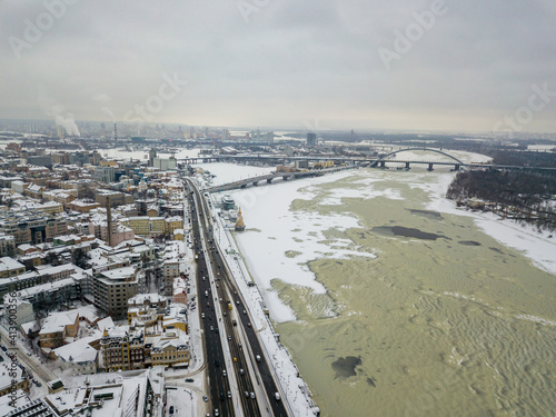 The freezing Dnieper river in Kiev. Snowy textures on the freezing river. Aerial drone view. Winter snowy morning.