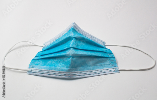 Blue surgical mask for face protection. The mask is used as a preventive protection against coronavirus.