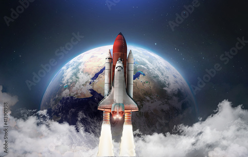 Fototapeta Naklejka Na Ścianę i Meble -  Spaceship in the outer space on orbit of Earth planet. Space shuttle in sky with clouds. Continents and oceans. Elements of this image furnished by NASA