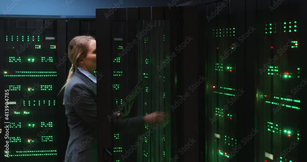 Blonde female programmer approaches technical closet in room with ...