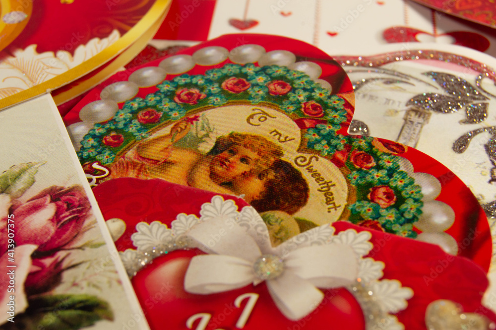 Close-up of a red valentine with a pattern of 2 angels on a background of valentines side view Close-up of a red valentine with a pattern of 2 angels on a background of valentines side view