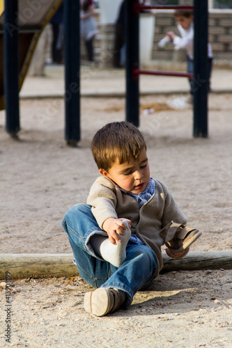 self-sufficient child putting on shoes