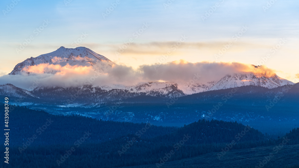 This image captures Mount Lassen and Chaos Crags semi-cloaked in low clouds during the golden hour in January as seen from the Hat Creek Rim in western Lassen County.