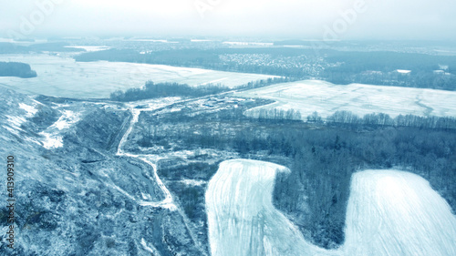 Top view from drone on blue snowy mountain in winter