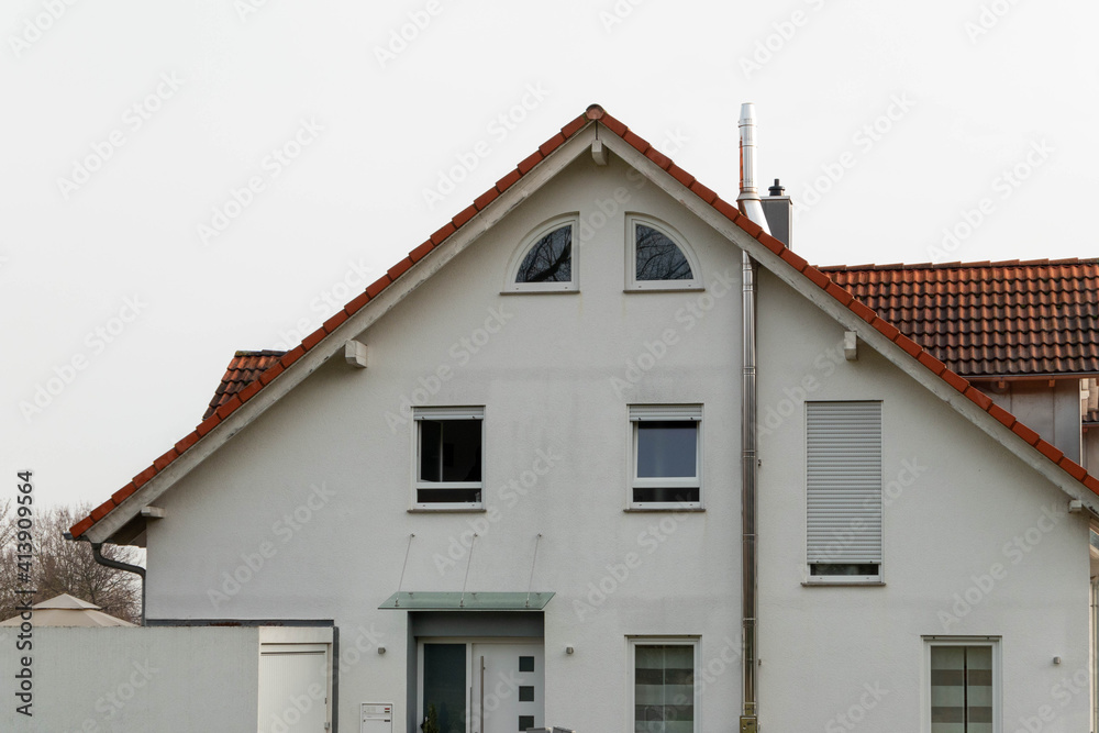 House facade with stainless steel chimney outside