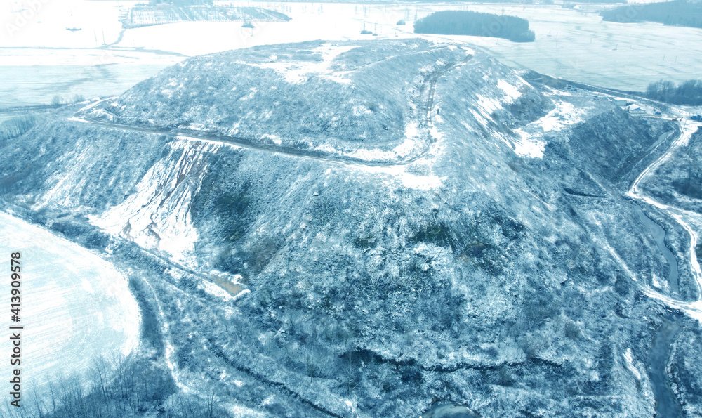 Top view from drone on blue snowy mountain in winter Top view from drone on blue snowy mountain in winter