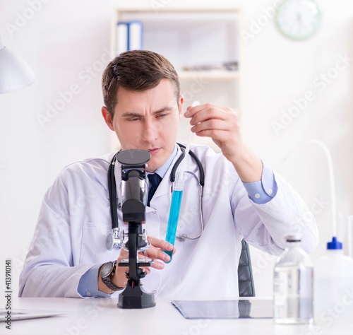 Male doctor looking at lab results in hospital