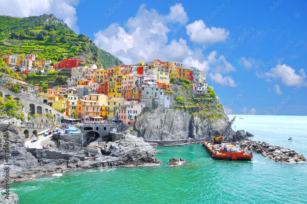 Beautiful view of Manarola town. Is one of five famous colorful villages of Cinque Terre National Park in Italy, suspended between sea and land on sheer cliffs. Liguria region of Italy, Europe.